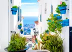 Narrow street in Mijas tourist town of the white villages in Andalusia, Spain